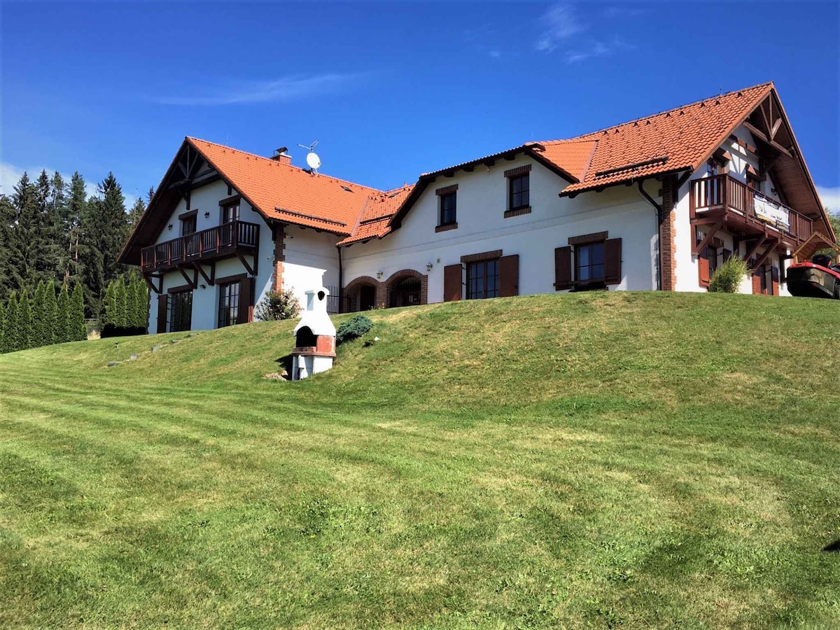 Holiday home with fireplace, sauna and garden at L