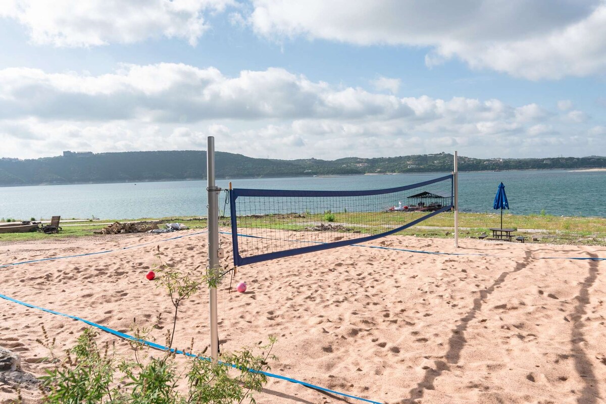 Lakefront Home with sand volleyball court by water