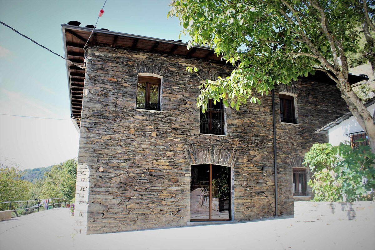 The house is an old stone manor house restored in a mountain area.