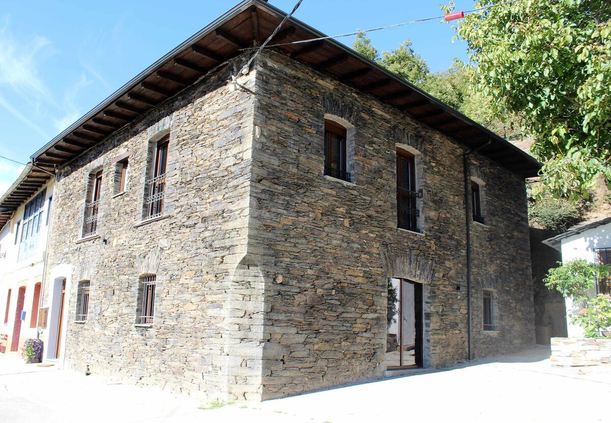 The house is an old stone manor house restored in a mountain area.