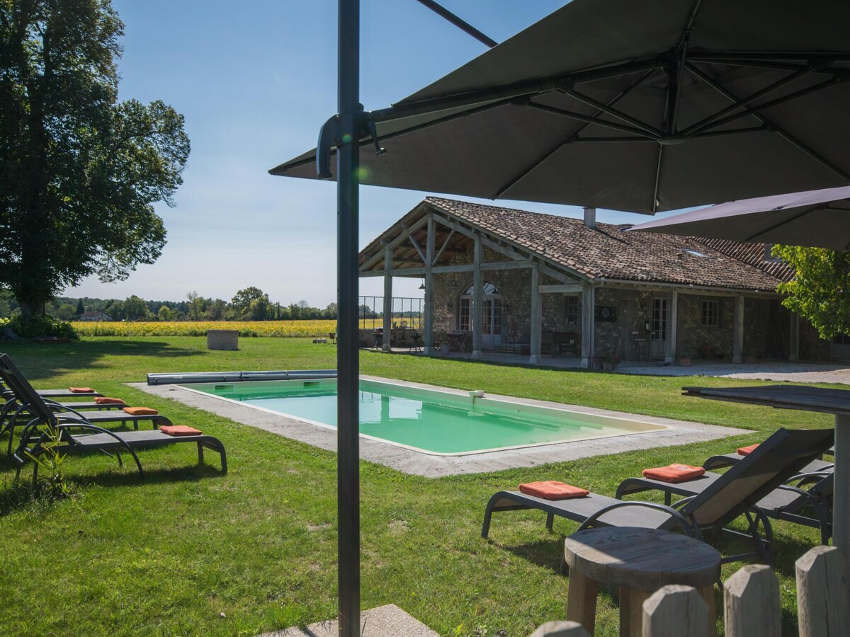 Country house with pool among sunflowers