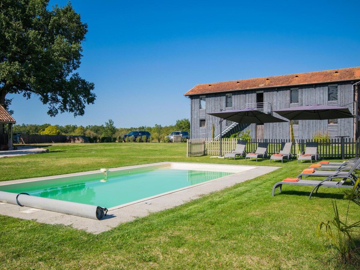 Country house with pool among sunflowers