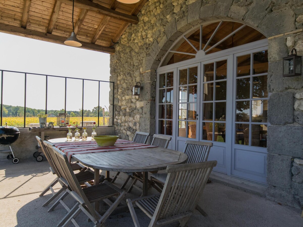 Country house with pool among sunflowers