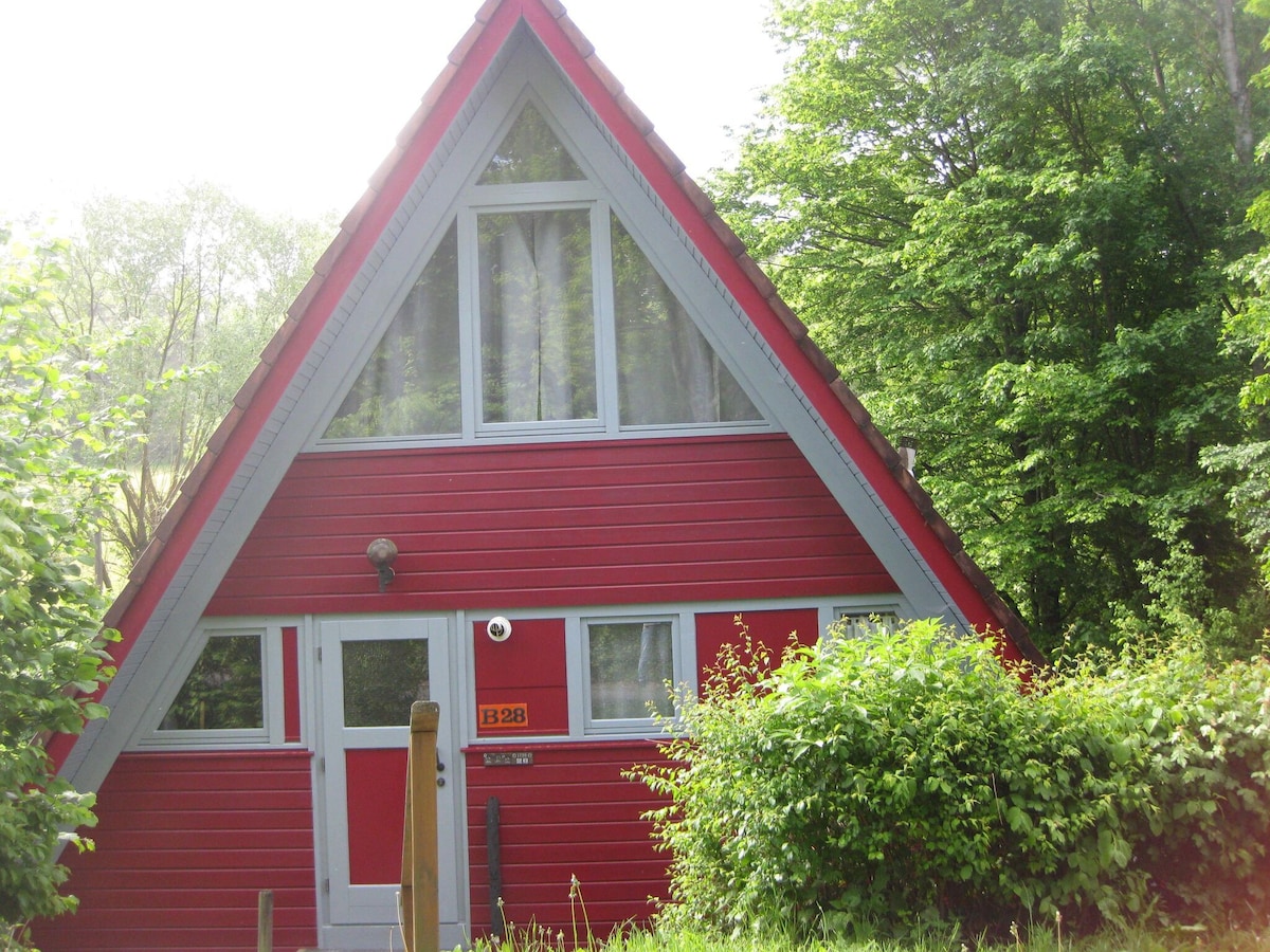 Wooden bungalow with a terrace, in a wooded area