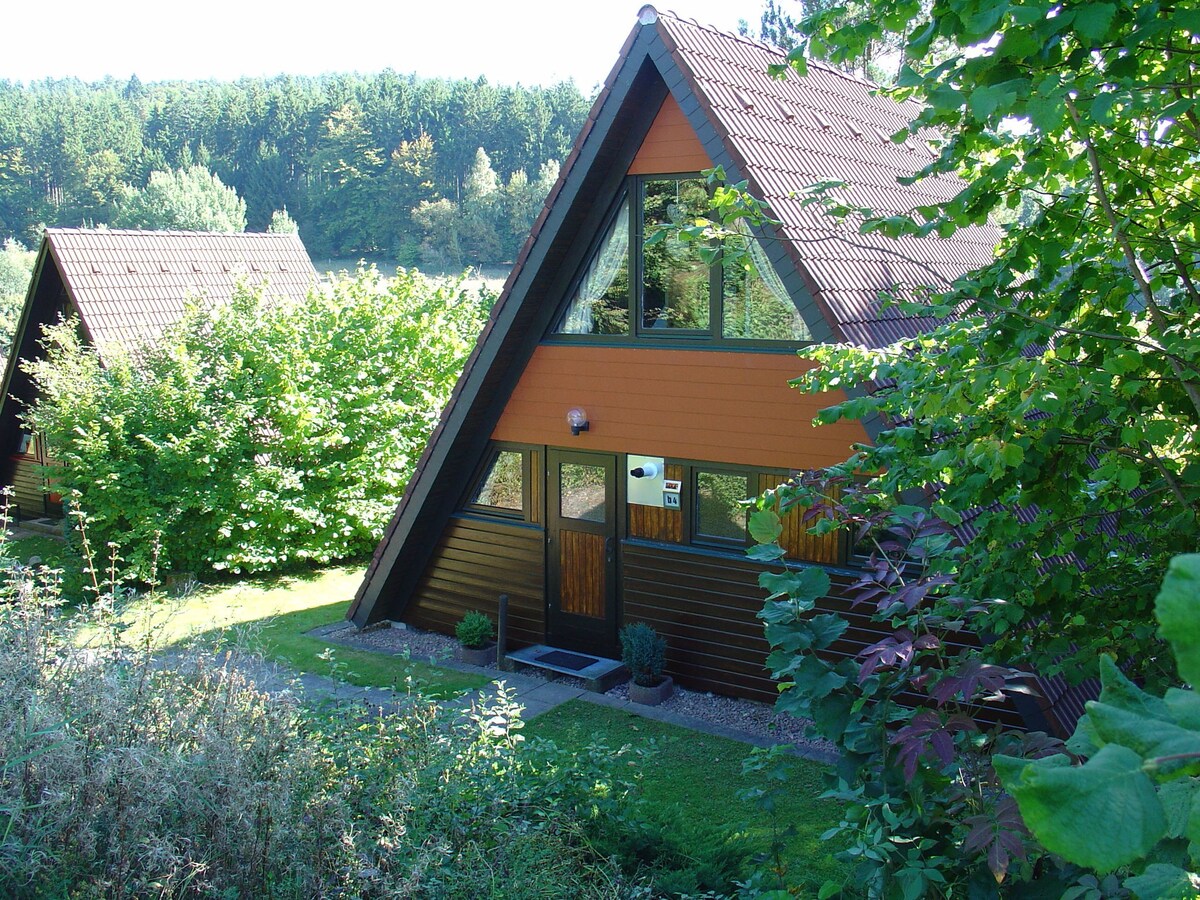 Wooden bungalow with a terrace, in a wooded area